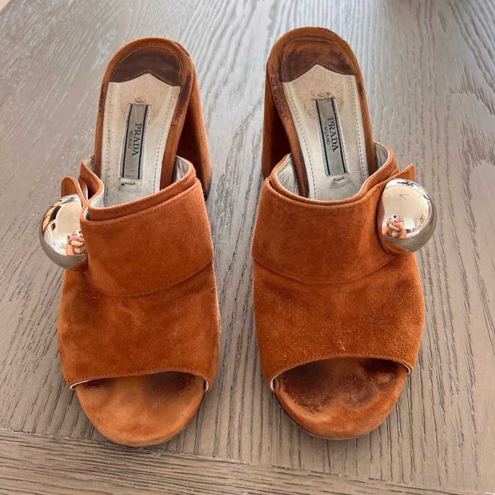 Prada slides with metal ball.